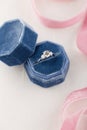 White golden wedding ring with diamonds in blue vintage velvet b Royalty Free Stock Photo