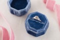 White golden wedding ring with diamonds in blue vintage velvet b Royalty Free Stock Photo