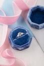 White golden wedding ring with diamonds in blue vintage velvet b Royalty Free Stock Photo