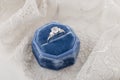 White golden wedding ring with diamonds in blue vintage velvet r Royalty Free Stock Photo