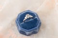 White golden wedding ring with diamonds in blue vintage velvet r Royalty Free Stock Photo