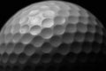 White golf ball on black background. Royalty Free Stock Photo