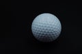 White golf ball on black background with copy space Royalty Free Stock Photo