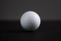 White golf ball on black background copy space Royalty Free Stock Photo