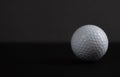 White golf ball on black background copy space Royalty Free Stock Photo