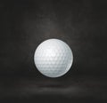 White golf ball on a black studio background Royalty Free Stock Photo