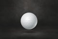 White golf ball on a black studio background Royalty Free Stock Photo