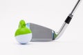 White golf ball with funny cap and golf club on the white background. Royalty Free Stock Photo