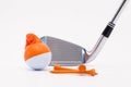 White golf ball with funny cap and golf club on the white background. Royalty Free Stock Photo