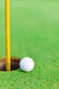 White golf ball on putting green