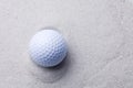White golf ball in sand trap