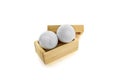 White Golf ball are stored in wooden boxes on a white background Royalty Free Stock Photo