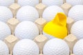 White golf balls in the box for eggs. Golf ball with funny cap. Royalty Free Stock Photo