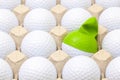 White golf balls in the box for eggs. Golf ball with funny cap. Royalty Free Stock Photo