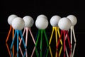 White golf balls and different colored tees Royalty Free Stock Photo