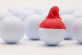 White golf balls with funny cap on the white background. Royalty Free Stock Photo