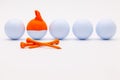 White golf balls with funny cap on the white background. Royalty Free Stock Photo