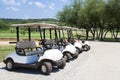 White golf carts lined up Royalty Free Stock Photo