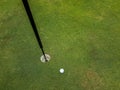 White golfball almost in the hole Royalty Free Stock Photo