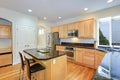 Sun filled gourmet kitchen with wooden cabinetry