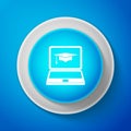 White Graduation cap and laptop icon. Online learning or e-learning concept icon isolated on blue background. Circle Royalty Free Stock Photo