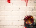 White Graffiti covered wall and building exhaust grate and pipe.