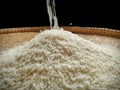 white grain rice poured into traditional flat bamboo basket Royalty Free Stock Photo