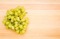 White grapes on a wooden cutting board