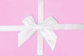 White gray bow with ribbon isolated on a pink background. The concept of cottages, holiday.