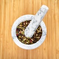 White and gray marble mortar and pestle with exotic pepper. Royalty Free Stock Photo