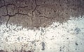 White and gray texture cracked concrete wall, half-painted with obsolete white paint Royalty Free Stock Photo