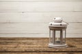 White or gray vintage lamps, candlesticks stand on a wooden table.