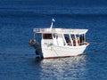 White Greek Caique Anchored in Calm Sea Water, Greece Royalty Free Stock Photo