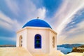 White Greek church and blue dome close-up, blue sky and clouds, Greece Royalty Free Stock Photo