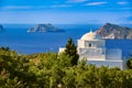 White Greek Orthodox chapel or church on top of hill, clear blue sky, sunny day. Milos, Greece Royalty Free Stock Photo