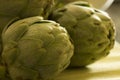 White and green artichokes on the table Royalty Free Stock Photo