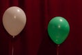 White and green balloons on a red background. For decoration design of the holiday. Royalty Free Stock Photo