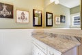 White and green bathroom witth marble-topped vanity.