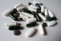 White, green and black tablets, caplets and capsules