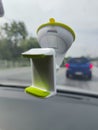 White green blank smartphone holder stuck in the windscreen of a car