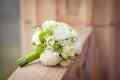 White and green bouquet on a stone parapet