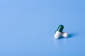 White-green capsules on a blue background to maintain health Royalty Free Stock Photo