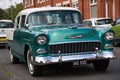 White and green 1955 Chevrolet Bel Air parked on the street.