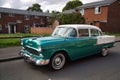 White and green 1955 Chevrolet Bel Air parked on the street.