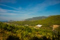 White green house on blue sky background. Plants crop in greenhouse. Closed rectangular greenhouse top view. Alanya, Turkey