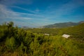 White green house on blue sky background. Plants crop in greenhouse. Closed rectangular greenhouse top view. Alanya, Turkey