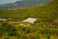 White green house on blue sky background. Plants crop in greenhouse. Closed rectangular greenhouse top view. Alanya, Turkey