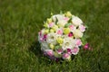 White green, pink and yellow and pink wedding bouquet with roses on the grass. Colorful image of beautiful nosegay Royalty Free Stock Photo