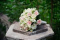 White green, pink and yellow and pink wedding bouquet with roses on the stone. Colorful image of beautiful nosegay Royalty Free Stock Photo