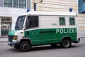 white and green police bus parked on street in Berlin near British Consulate, symbol law and order, international cooperation in